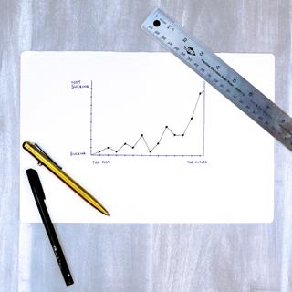 Notebook with hand-drawn chart of a product getting better over time.